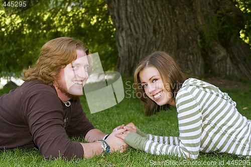 Image of Young couple holding hands in the Park