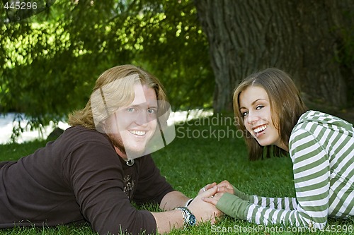 Image of Young couple holding hands in the Park