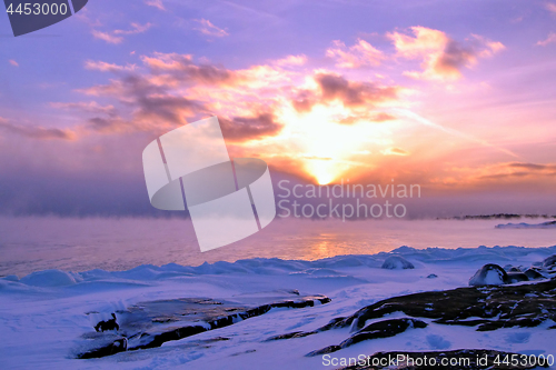 Image of Sunset and cold fog spreads over freezing northern sea