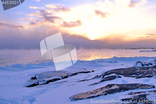 Image of Sunset and cold fog spreads over freezing northern sea