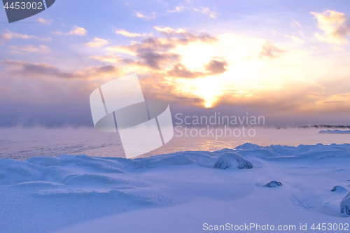 Image of Sunset and cold fog spreads over freezing northern sea