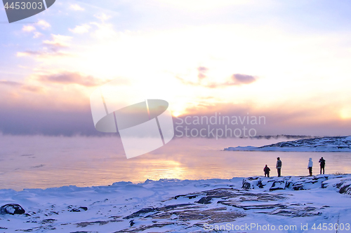 Image of Sunset and cold fog spreads over freezing northern sea