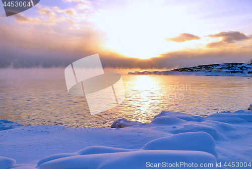 Image of Sunset and cold fog spreads over freezing northern sea