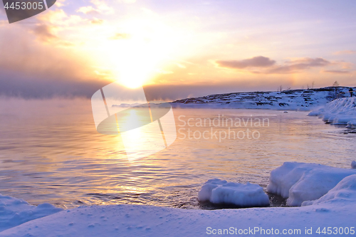 Image of Sunset and cold fog spreads over freezing northern sea