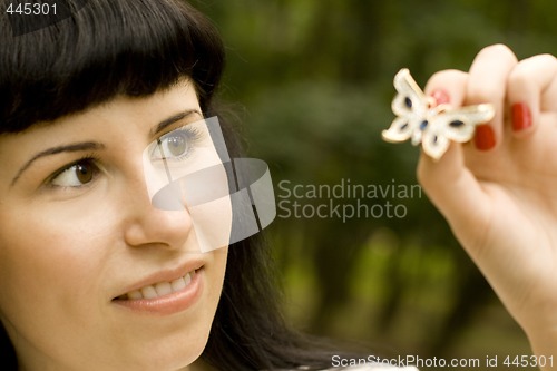 Image of pretty young brunette with brooch