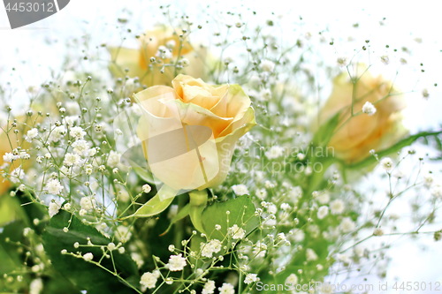 Image of Beautiful bouquet of yellow roses and white little flowers with blur background