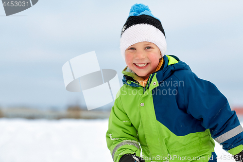 Image of happy little boy in winter clothes outdoors