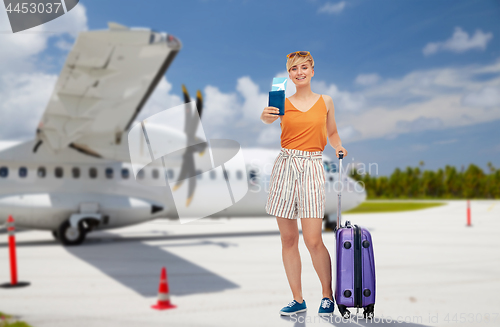 Image of teenage girl with travel bag and airplane ticket