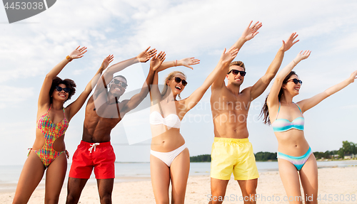 Image of happy friends having fun on summer beach