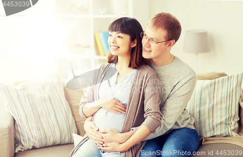 Image of happy pregnant wife with husband at home