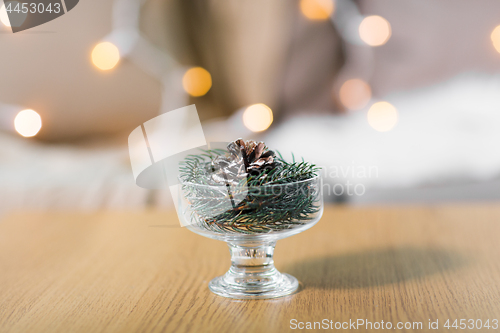 Image of christmas fir decoration with cone in dessert bowl