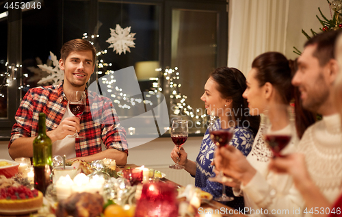 Image of friends celebrating christmas and speaking toast
