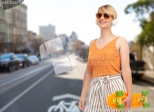 Image of teenage girl with skateboard over san francisco