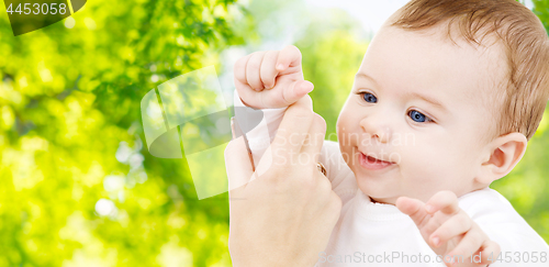 Image of close up of sweet little baby with mother hand