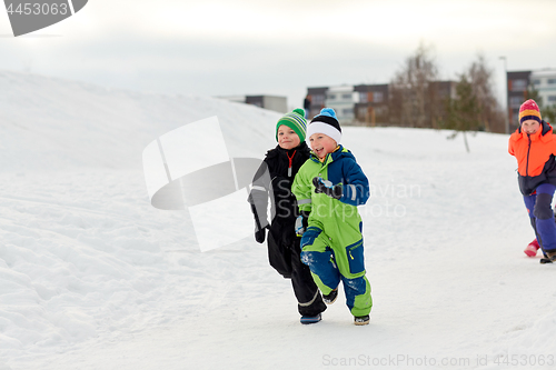 Image of happy little kids running outdoors in winter