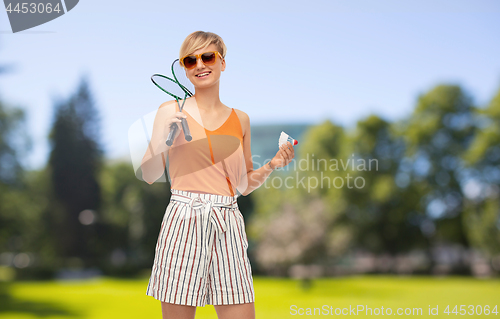 Image of teenager with badminton rackets and shuttlecock