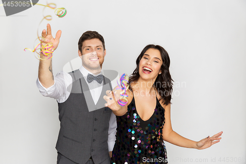 Image of happy couple with serpentine party and having fun