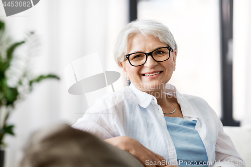 Image of portrait of happy senior woman in glasses at home