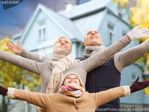 Image of happy family over living house in autumn
