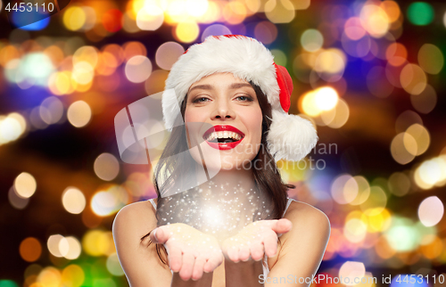 Image of woman with red lipstick in santa hat at christmas