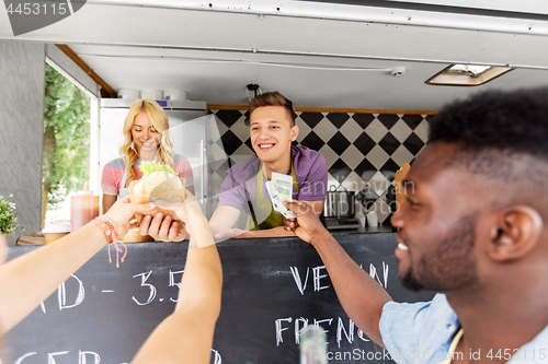 Image of happy customers buying burger at food truck