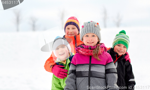 Image of happy little kids in winter clothes outdoors