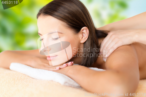 Image of close up of beautiful woman having massage at spa