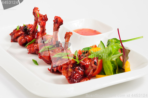 Image of fried chicken wings in pomegranate sauce