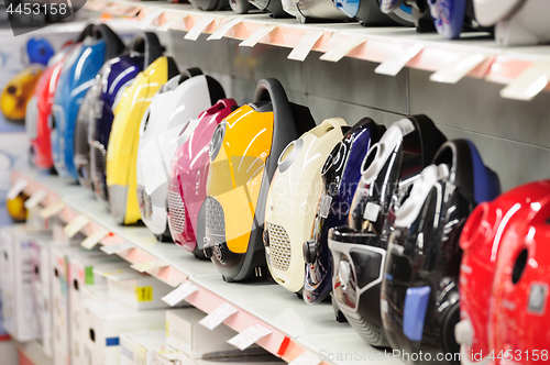Image of vacuum cleaners in appliance store arranged in a row