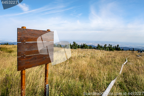 Image of Wooden multi sign on the top of a hill