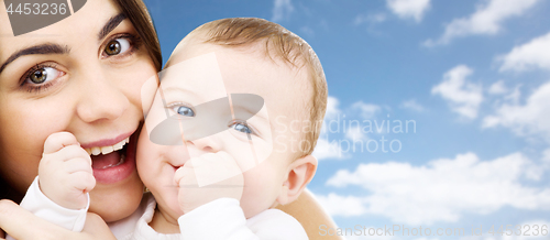 Image of mother with baby over sky background