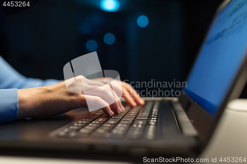 Image of close up of female hands with laptop typing