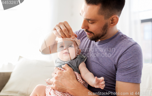 Image of close up of father with little baby girl at home