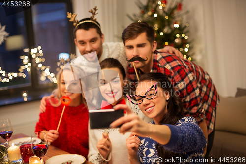 Image of friends taking selfie at christmas dinner