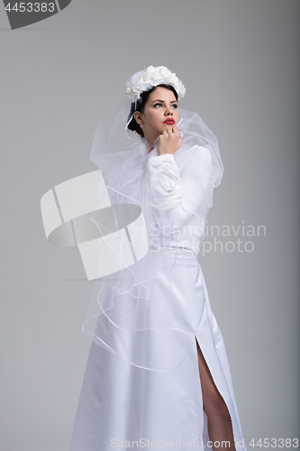 Image of young bride in a wedding dress with a veil