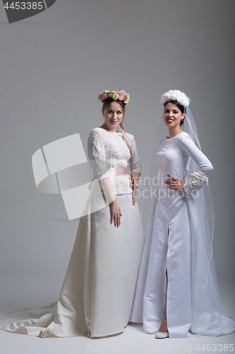 Image of Portrait of two beautiful young bride in wedding dresses