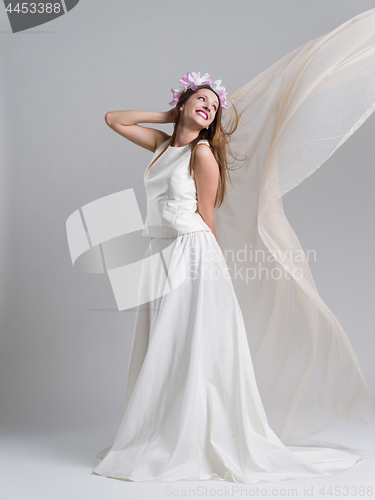 Image of young bride in a wedding dress with a veil