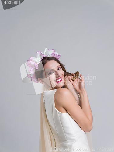 Image of young bride in a wedding dress with a veil