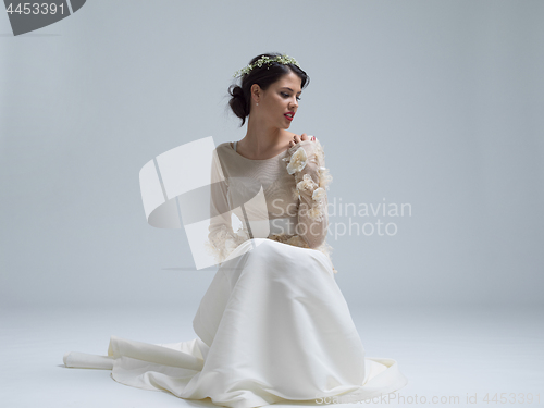 Image of young bride sitting in a wedding dress