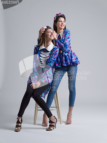 Image of two Fashion Model girls isolated over white background