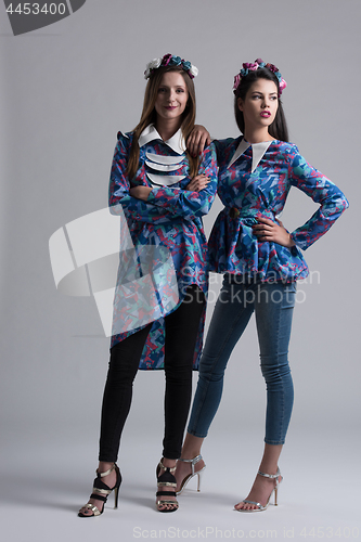 Image of two Fashion Model girls isolated over white background