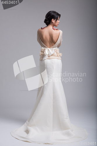 Image of Rear view of a beautiful young woman in a wedding dress