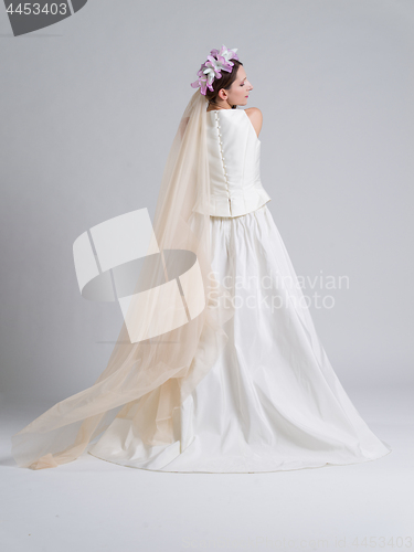 Image of Rear view of a beautiful young woman in a wedding dress