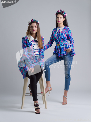 Image of two Fashion Model girls isolated over white background