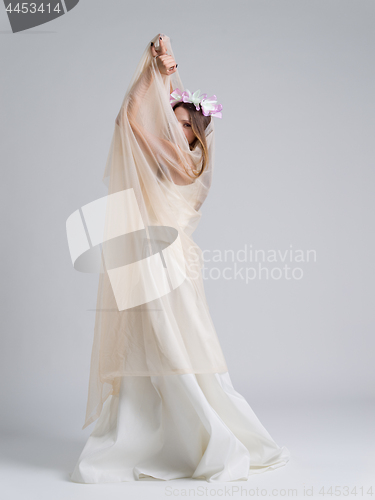 Image of young bride in a wedding dress with a veil