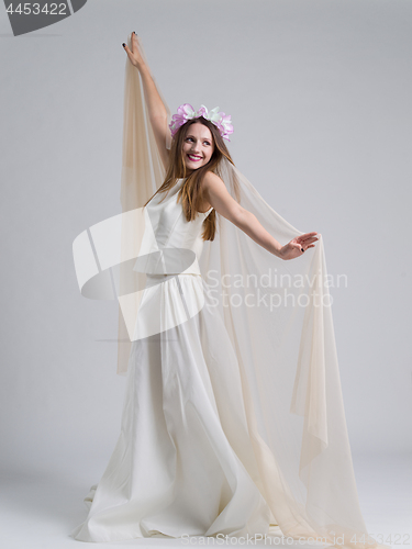 Image of young bride in a wedding dress with a veil