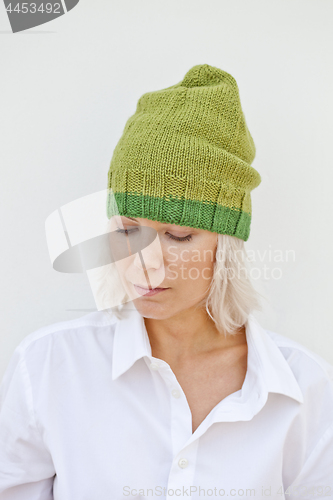 Image of Beautiful young woman in warm green hat.