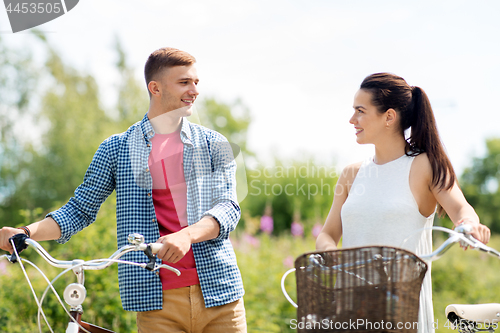 Image of happy couple with fixed gear bicycles in summer