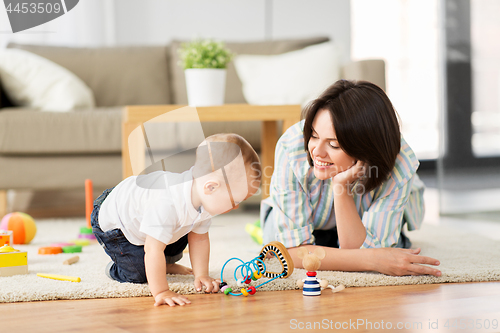 Image of happy mother with little baby son playing at home