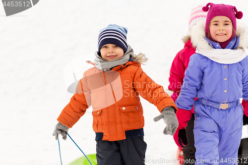 Image of happy little kids with sleds in winter